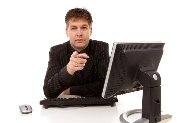 Businessman sitting behind desk is pointing at you — Stock Photo, Image