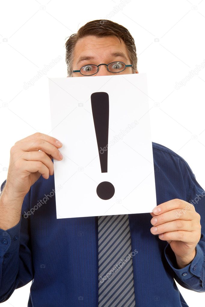 Male nerdy geek is holding text board with exclamation mark