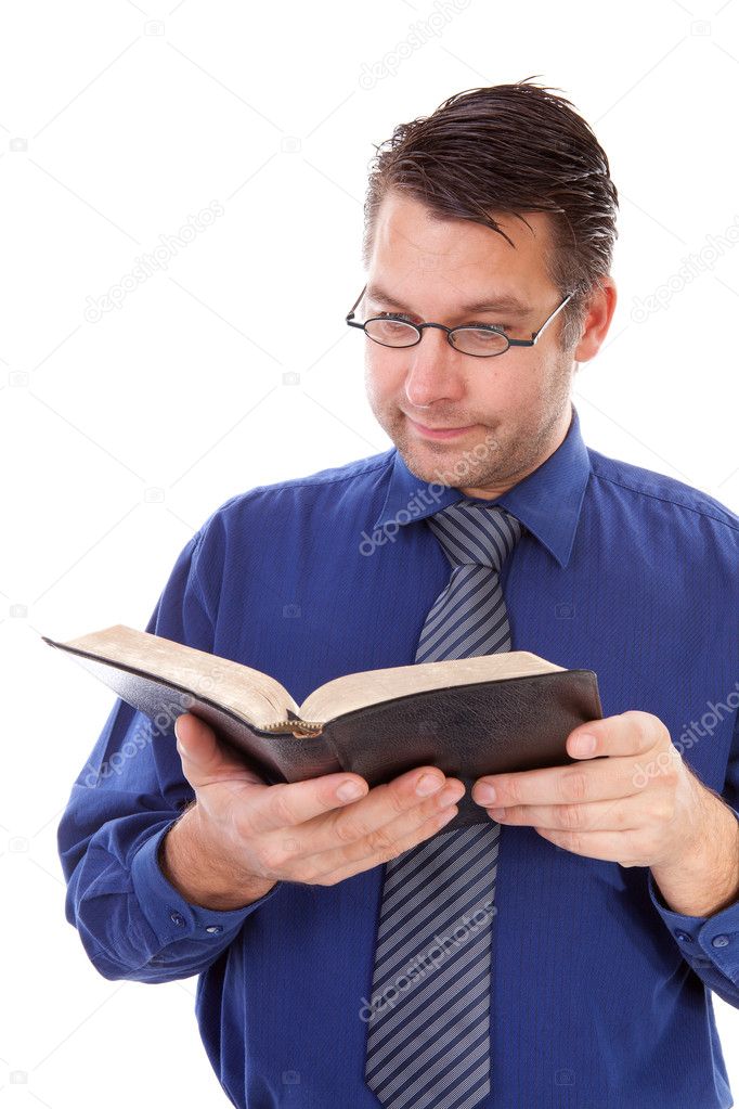 Male nerdy geek is reading a book
