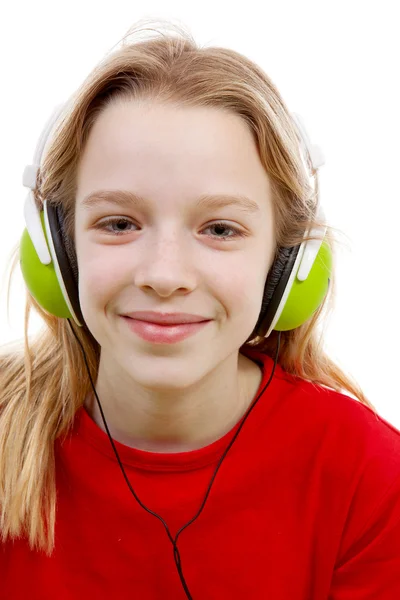Girl is listening to music with headphones on — Stock Photo, Image