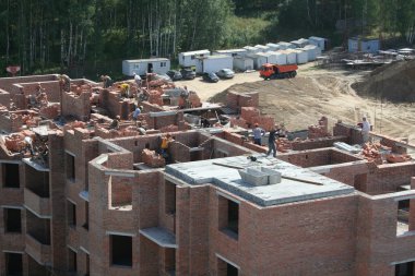 Construction workers at a workplace. clipart