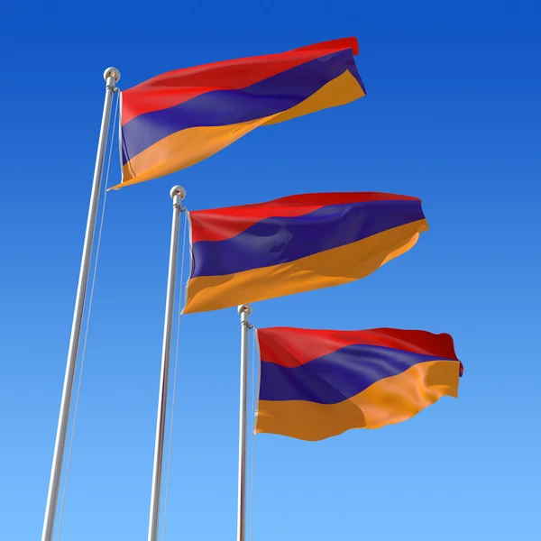 Tre flaggor av Armenien mot blå himmel. — Stockfoto