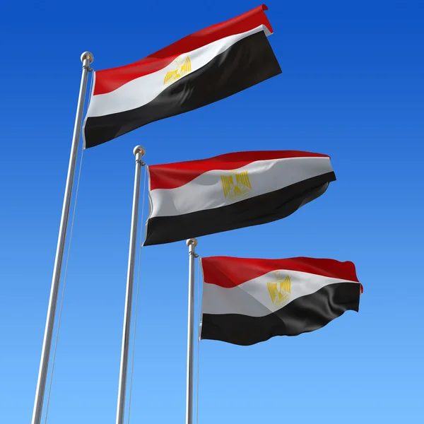 Drie vlaggen van Egypte tegen blauwe hemel. — Stockfoto