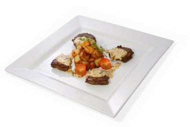 Sirloin steak with sauted potatoes and fresh cherry tomatoes on a white plate. clipart