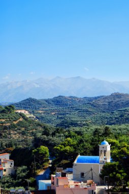 An elevated view of a church near to the town of Platanias on the greek island of Crete. clipart