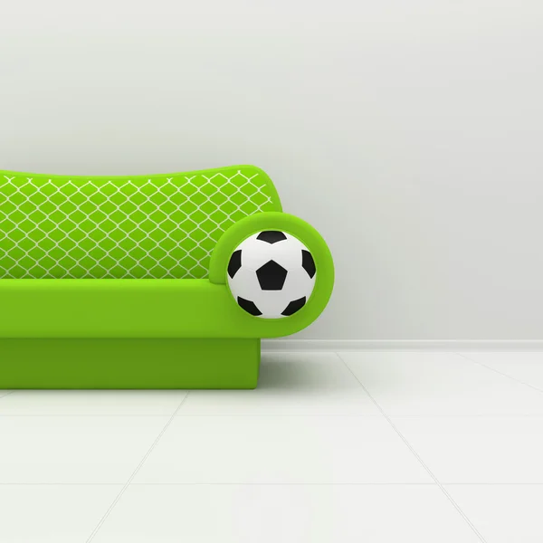 Sofá verde com simbólica de futebol — Fotografia de Stock
