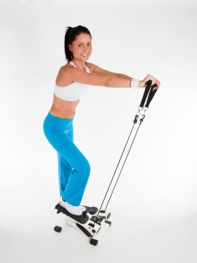 Woman working out on stepper trainer clipart