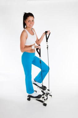 Woman working out on stepper trainer clipart