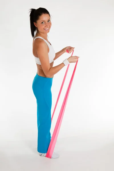 Woman exercising with rubber ribbon — Stock Photo, Image