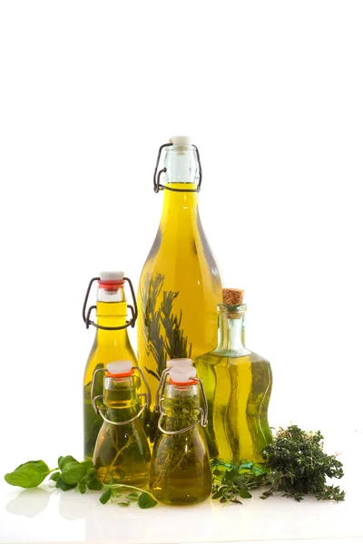 Bottles olive oil with herbs — Stock Photo, Image