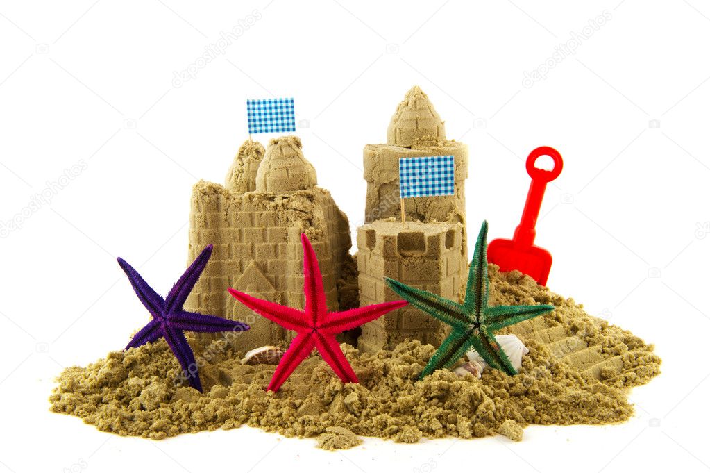 Sandcastle at the beachwith starfishes isolated over white