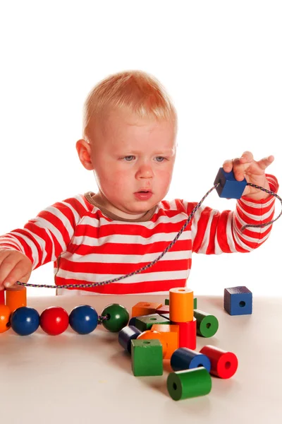 Little Blond Boy Playing Colorful Wooden Beads — Stock Photo, Image