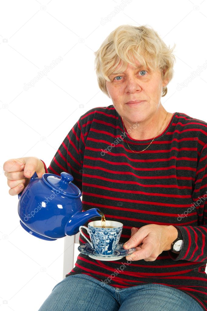 Elderly woman is drinking a cup of tea