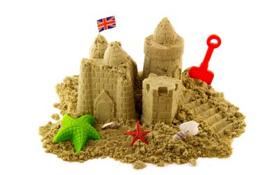 Sandcastle at the beach on vacation isolated over white clipart
