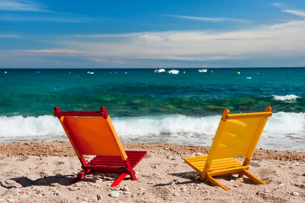 静かなビーチで空のオレンジ色と黄色の椅子 — ストック写真