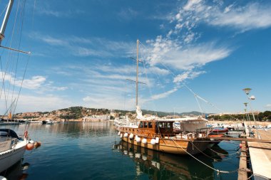 Harbor with wooden sailboat in San Feliu de Gauxols clipart