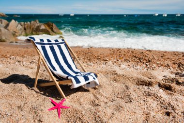 Empty chair at the beach clipart