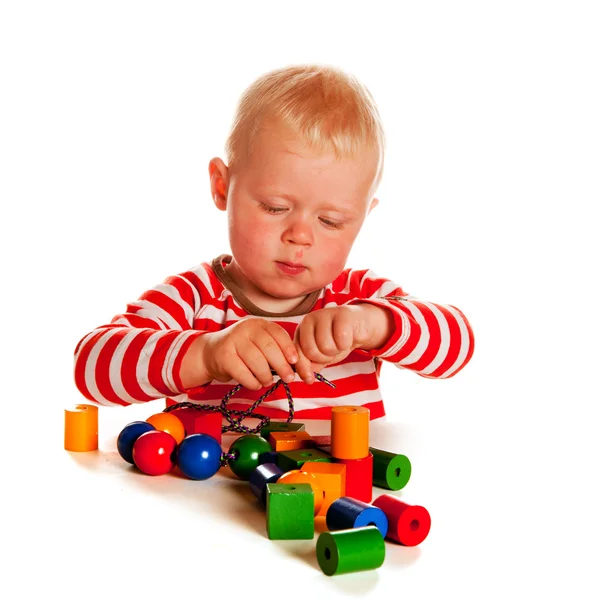 Little boy playing with beads — Stock Photo, Image