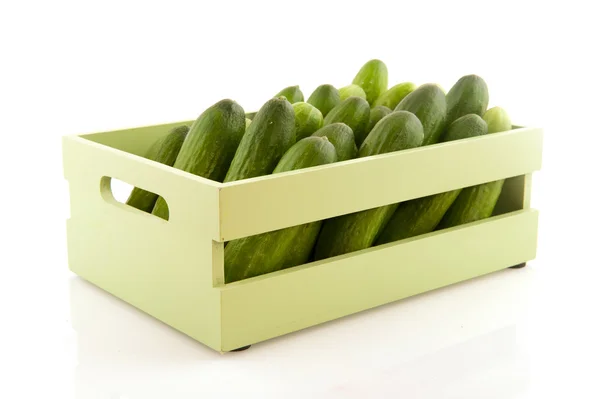 Many cucumbers in wooden crate — Stock Photo, Image