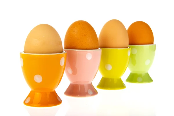 Eggs in colorful cups — Stock Photo, Image