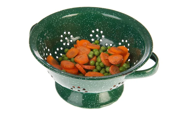 Green colander with vegetables — Stock Photo, Image