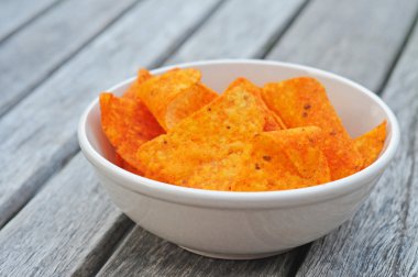 White bowl with paprika dorito's, shallow dof clipart