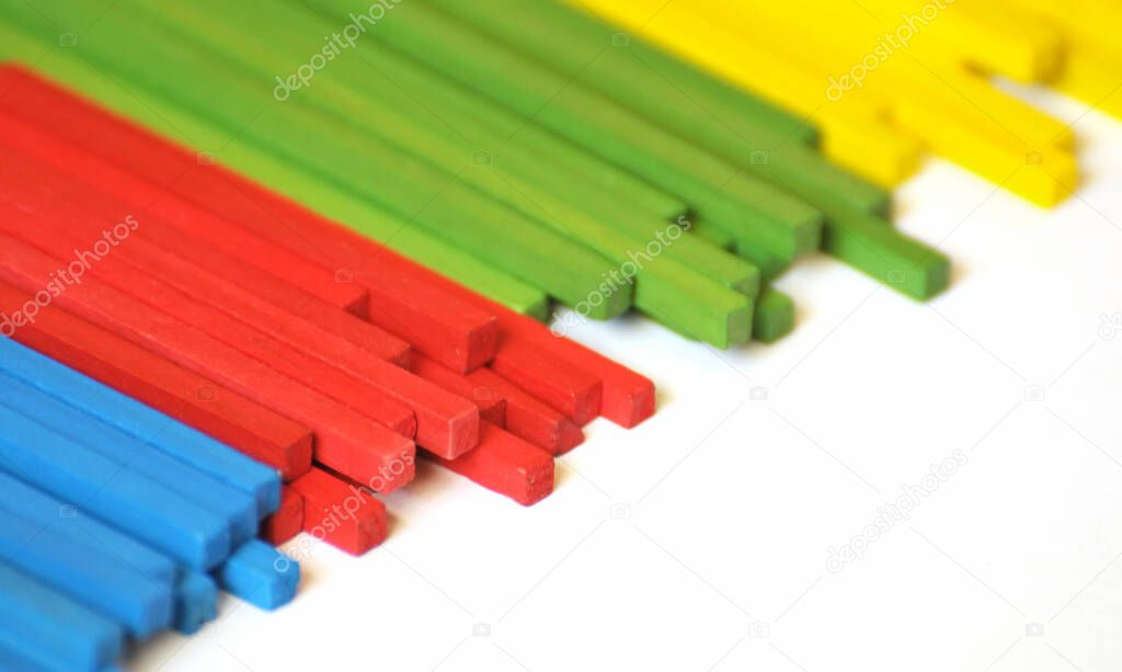 The blue, red, green and yellow wooden sticks