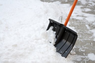 Using snow shovel on a backyard clipart