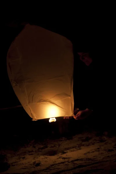 stock image Playing with flying lantern in the night