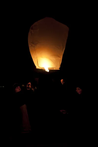 Stock image Playing with flying lantern in the night