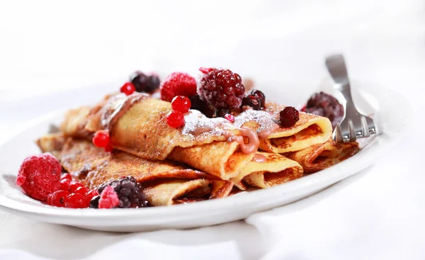 Crepes filled with chocolate and berries — Stock Photo, Image