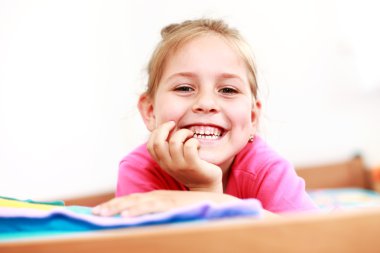 Beautiful small girl is smiling sincerely clipart