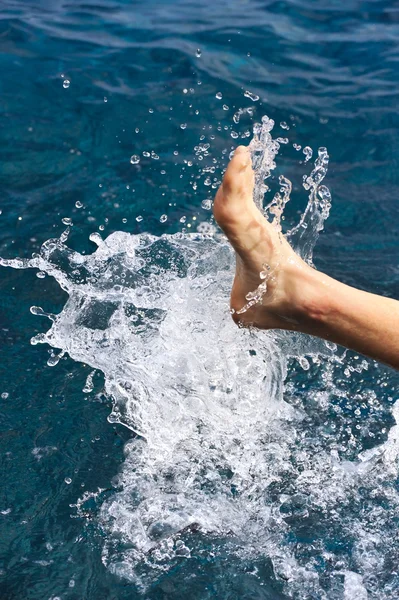 stock image Foot of young man in water - splash