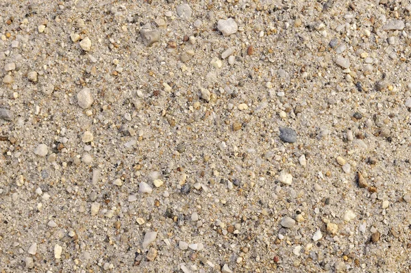 Detalle de textura de arena con piedras pequeñas - fondo — Foto de Stock