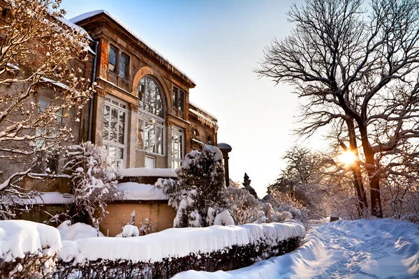 stock image Winter - old, ancient house all in snow - golden sunset