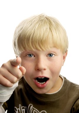 Cute amazed blond boy, pointing with his finger, isolated on white background clipart
