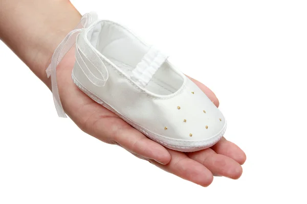 Shoe for infant on woman hand — Stock Photo, Image