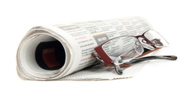 Roll of newspapers with eyeglasses , isolated on white background clipart