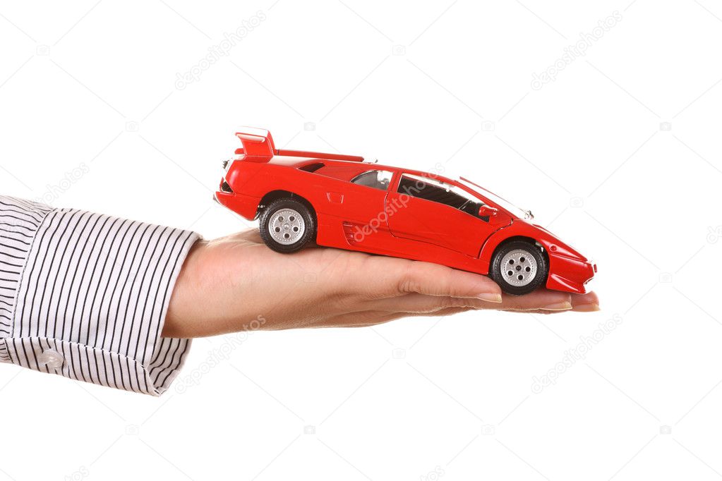 Woman hand with holding red sports car