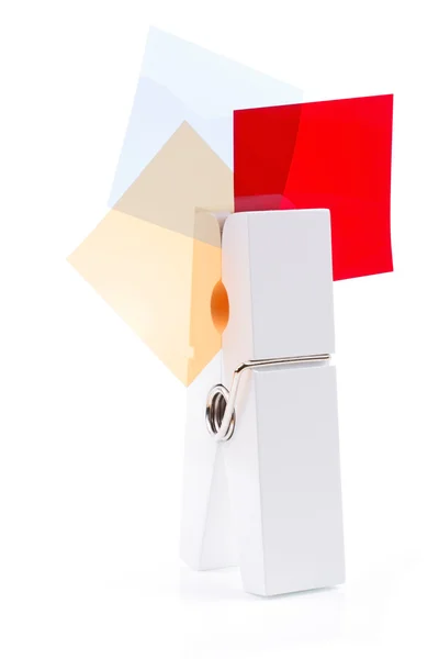 Pinza blanca con tres cuadrados coloreados aislados —  Fotos de Stock