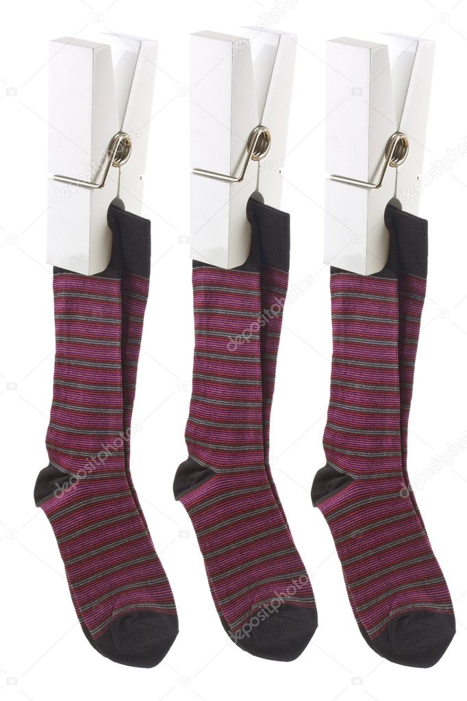 White pegs holding up red socks