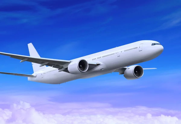 Білий пасажирський літак приземляється в блакитному небі
