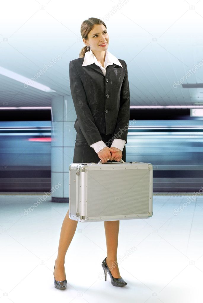 Business traveler with luggage and speed train on station