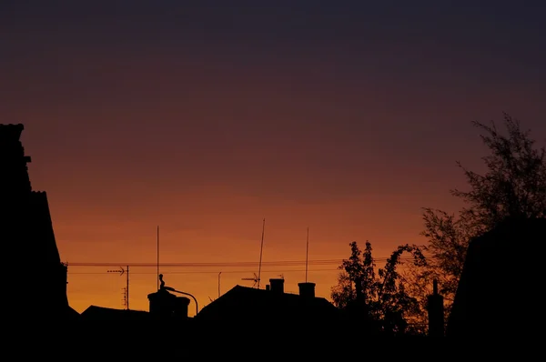 stock image Sunset, roofs and chimney shafts