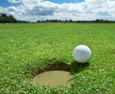 Golf ball at the hole clipart