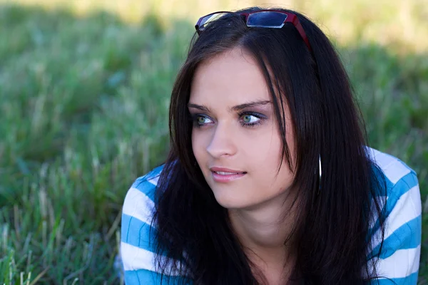 Girl on the meadow with glasses — Stock Photo, Image