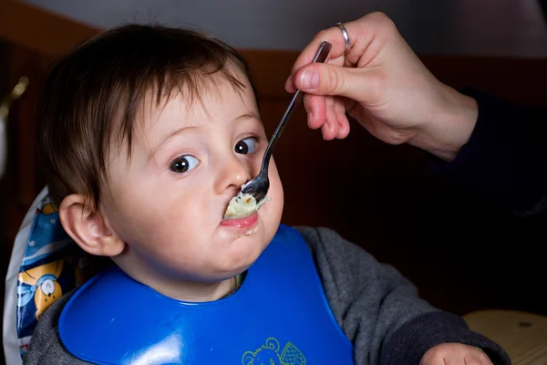 Baby boy eating a dinner — Stock Photo, Image