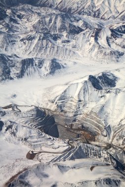 Aerial view of open-pit mine under snow in Atacama desert, Chile clipart