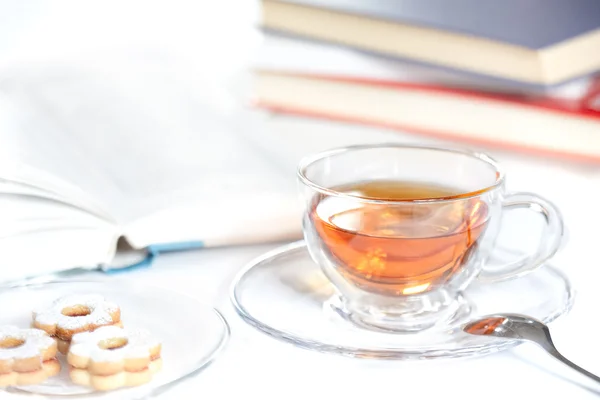 stock image Cookies, glass of tea and books on the table