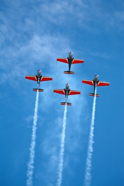 Four airplanes in formation on airshow clipart